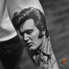 a man's arm with an elvis presley tattoo on it