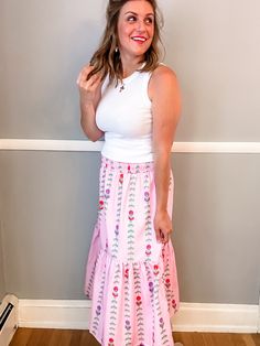 Transform your summer wardrobe with our Pink Tulip Tiered Skirt. This playful and fun piece features a stunning pattern and beautiful colors, perfect for bringing a pop of color to any outfit. With a smocked waist and lining, it not only looks great but also offers a comfortable fit. A must-have for any fashion-forward individual looking to make a statement! Fit is true to size. Emily is 5'8" wearing a medium. Small (0-4) Medium (6-8) Large (10-12) XL (14-16) Feminine Maxi Skirt For Summer Vacation, Summer Gathered Maxi Skirt For Day Out, Spring Floral Print Stretch Maxi Skirt, Spring Feminine Stretch Maxi Skirt, Stretch Floral Print Skirt For Day Out, Feminine Stretch Maxi Skirt For Spring, Spring Vacation Gathered Maxi Skirt, Spring Vacation Maxi Skirt With Gathered Detail, Feminine Summer Maxi Skirt For Day Out