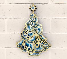 a blue and gold christmas tree ornament on a white brick wall