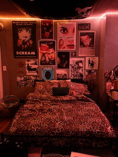 a bedroom with posters on the wall and a leopard print bed spread