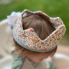 Perfect for dress up, pretend play, or a birthday celebration this sweet floral crown is made of 100% cotton. It features a floral print with pink, blue and peach on a light background. The crown fits most kids 1+. Capture those birthday party memories or foster imaginative play all while looking adorable.  The crown body measures 16x4 inches, with adjustable white ties. The crown is soft and puffy, but stands up well.  Care - machine wash in cool water and dry on low heat or hang dry. Iron if n Crown Dress, White Ties, Fabric Crown, Crown Pink, 2024 Halloween, Toddler Play, First Birthday Gifts, Birthday Crown, Easter Girl