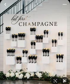 there are many wine glasses on display in front of the sign that says, champagne