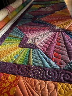 a close up view of a colorful quilt