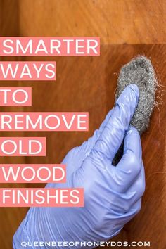 a gloved hand removing wood from a wall with text overlay that reads, smart ways to remove old wood finishes