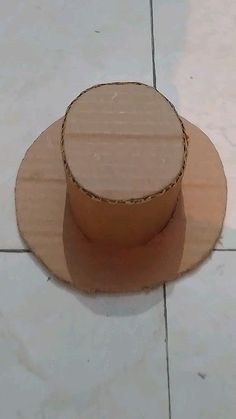 a wooden object sitting on top of a white tile floor