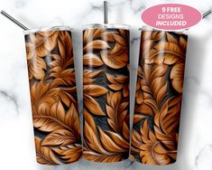 three matching tumblers with floral designs on them, one is brown and the other is black