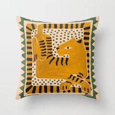 a yellow and green pillow with a tiger on it