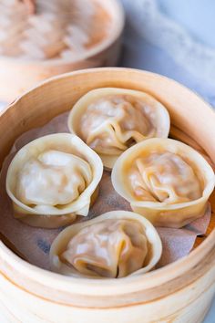 some dumplings are sitting in a wooden container