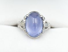 "A magical 7.78 carat natural unheated light blue star sapphire is the center to this wonderful Art Deco vintage BIRKS platinum setting. The star sapphire measures 13x9.5mm across. It does not display a perfect 6-legged star, but it does show very noticeable asterism. The color and glow of the sapphire, and the beauty and uniqueness of this vintage setting makes for an amazing piece of jewelry. Round single cuts and long baguettes accent the piece, totaling approximately 0.15 carat. The ring wei Classic Blue Moonstone Ring For Formal Occasions, Vintage Gia Certified Sapphire Jewelry, Vintage Blue Sapphire Oval Cabochon Ring, Blue Star Sapphire Ring, Vintage Setting, Platinum Diamond Wedding Band, Victorian Style Jewelry, Platinum Diamond Ring, Star Ruby Ring