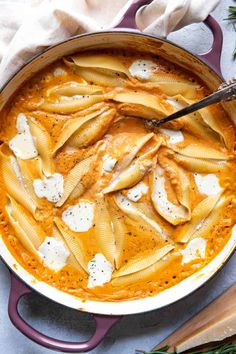 a pan filled with pasta and cheese on top of a table