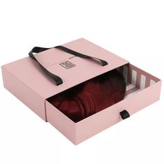 a pink box with some red hair in it