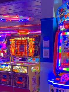 two arcade machines with neon lights in the background