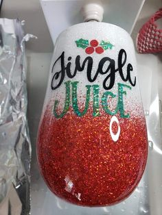 a red and white wine glass with the words ginger juice painted on it's side