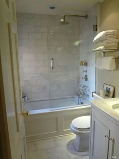 a bathroom with a toilet, sink and bathtub