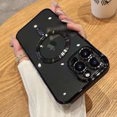 a woman's hand holding an iphone case with multiple buttons