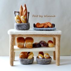 breads and pastries are displayed on a small table with the words felt by winnace