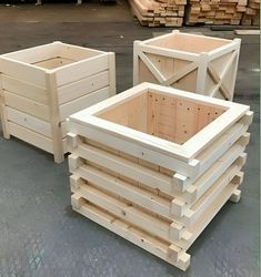 several wooden crates stacked on top of each other in front of stacks of wood planks