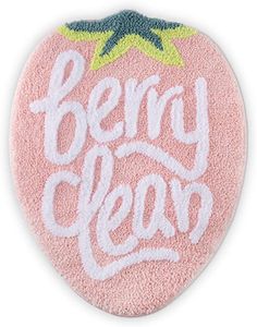 a pink and white bath mat with the words berry clean on it's side