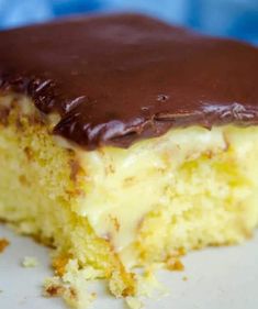 a piece of cake with chocolate frosting on it sitting on top of a white plate