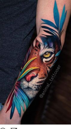 a man with a tiger tattoo on his arm and the face of a tiger is shown