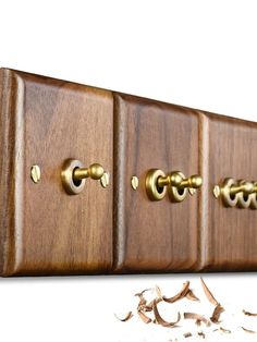 a close up of a wooden guitar neck with brass knobs on it's sides