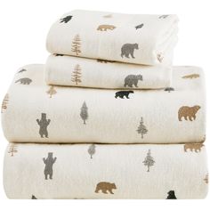 three towels stacked on top of each other with bears and pine trees printed on them