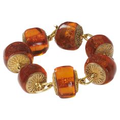 An antique amber and gold bracelet, with large amber beads, with gold discs either side, decorated with Etruscan style wirework, with single oval gold links, in a Richard A. Green fitted case, with gold M. A. S. initials, in gothic script, circa 1875. Richard Angell Green traded from 82 Strand, WC. He was elected as a member of the Society for the Encouragement of Arts, Manufacturers and Commerce in 1859. His address appears in the 1862 Post Office directory. He applied for a patent for the design or production of earrings, on 31st December, 1870. He sold jewellery of classical design. Condition: Good, with some crazing to the amber Vintage Gold Beaded Bracelets For Gift, Gothic Script, Faberge Jewelry, Antique Bracelets, Gold Armband, Gold Disc, Amber Beads, Amber Jewelry, For The