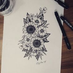 a drawing of sunflowers with leaves and flowers in the center on a piece of paper