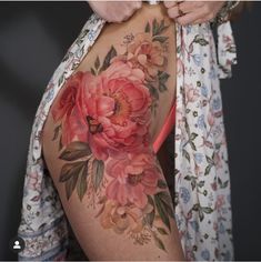 a woman with a flower tattoo on her back