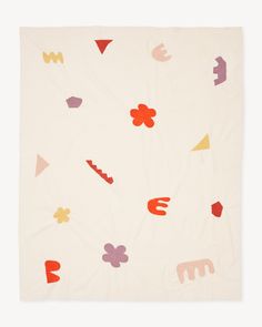 a white blanket with colorful shapes on it