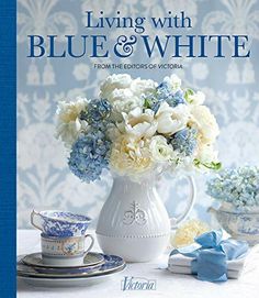 the cover of living with blue and white from the potters victoria, featuring flowers in a vase