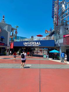 the entrance to universal studios with people walking around