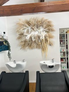 two white sinks sitting next to each other in a room