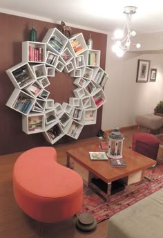 a living room filled with furniture and a large circular book shelf on the wall above it