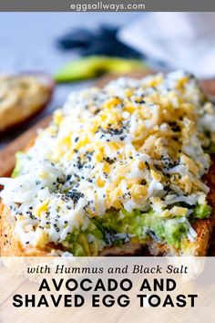 avocado and shaved egg toast with hummus and black salt