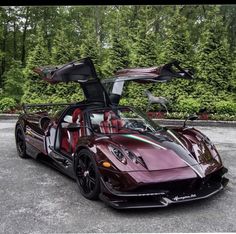 a maroon sports car parked in a parking lot