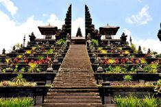 the stairs lead up to an elaborately decorated building with flowers and plants on each side