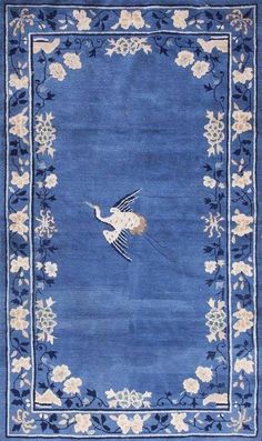 a blue rug with an image of a bird on it