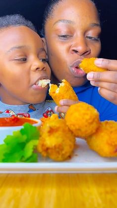 two children are eating fried food at the table