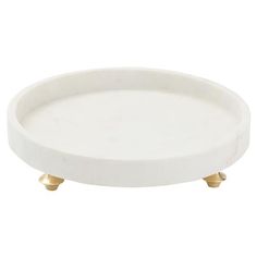 a white plate with gold legs on a white background