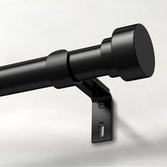 a telescope mounted to the side of a wall with a black cover on it's end