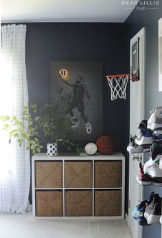 a basketball themed room with shoes on the floor and an art piece hanging above it