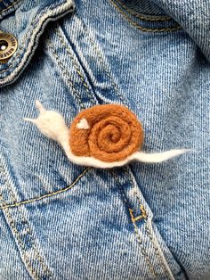 a close up of a denim jacket with a flower on it