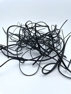 a pile of black wire sitting on top of a white table