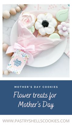 mother's day cookies on a white plate with pink ribbon and flower treats for mother's day