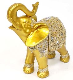 an elephant figurine in gold and white with diamonds on it's trunk