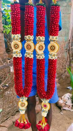 a man standing in front of some red beads