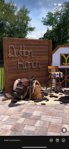 a wooden sign with the words cotton ranch written on it next to a pile of shoes