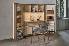 a chair sitting in front of a desk with a book shelf on top of it