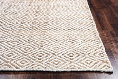 a close up of a rug on a wooden floor with wood floors in the background